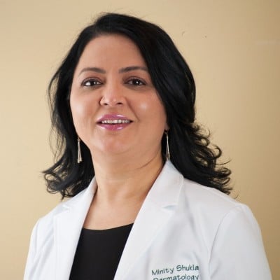 Woman with Black Hair Smiling in Lab Coat